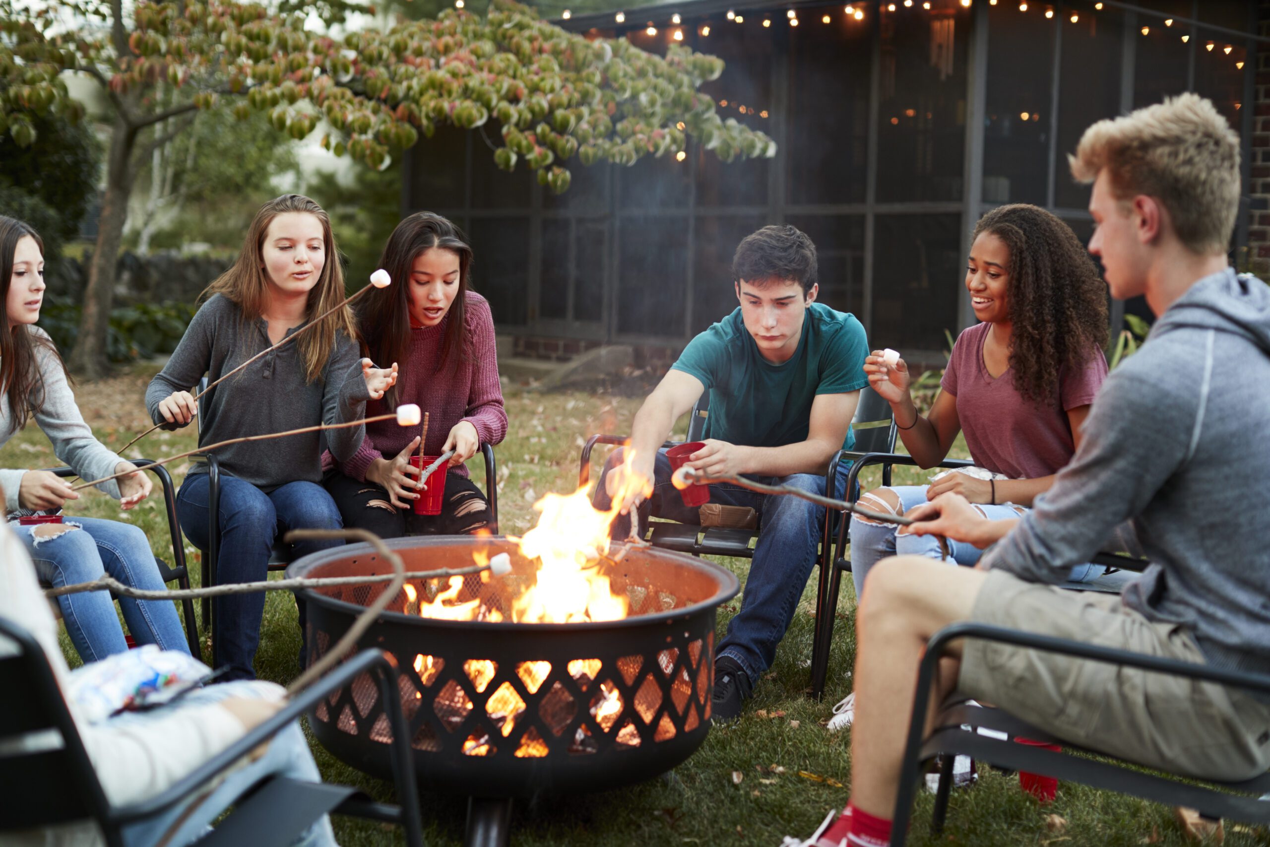 Corporate team gathered around a firepit at an offsite